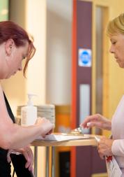 Two women talking and completing a survey